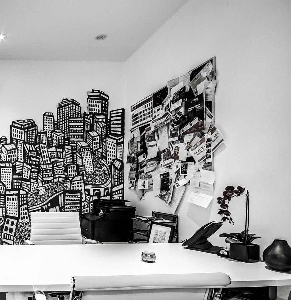Forest Hill workspace with an inspiration wall and skyline mural